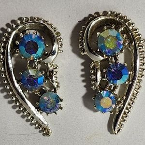 Earrings silver tone with graduating blue ab rhinestones shaped like "6".  1.5"